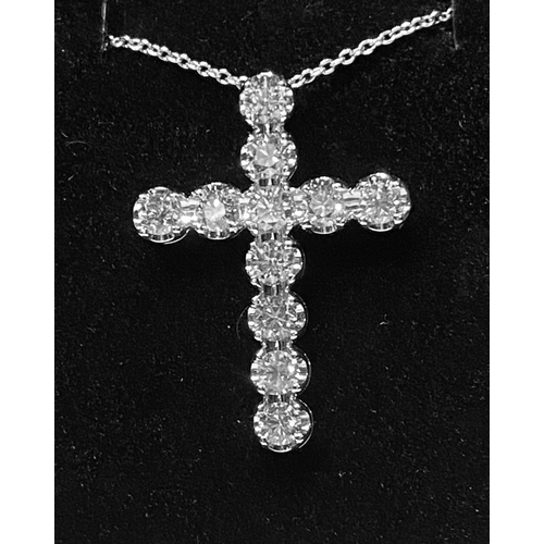 150 - A BRILLIANT CUT DIAMOND CROSS PENDANT, in a claw setting on an 18ct white gold chain. There are 11 G... 