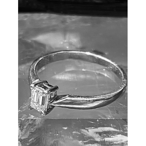 177 - A PLATINUM CLAW SET DIAMOND RING, the platinum claw set ring is set with an emerald cut diamond with... 