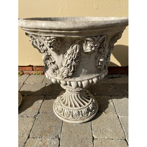 207 - A LARGE PAIR OF STONE GARDEN URNS, each with detailed decoration of fruit and foliage with green-man... 