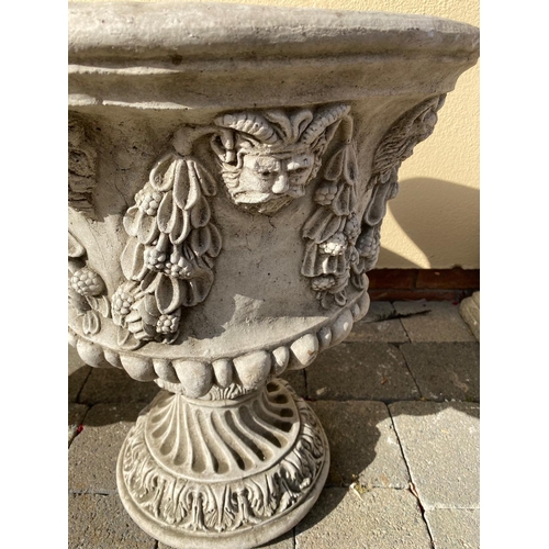 207 - A LARGE PAIR OF STONE GARDEN URNS, each with detailed decoration of fruit and foliage with green-man... 