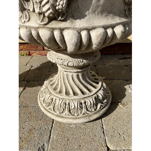 207 - A LARGE PAIR OF STONE GARDEN URNS, each with detailed decoration of fruit and foliage with green-man... 