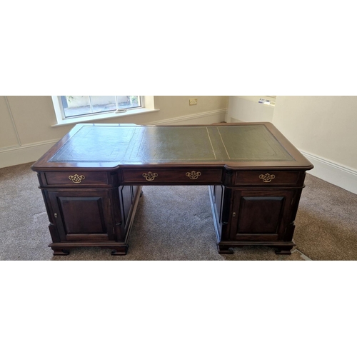 21 - A VERY FINE MAHOGANY LEATHER TOPPED PARTNERS DESK, the concave break front to the front and back add... 