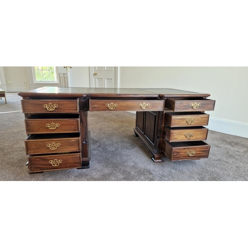 21 - A VERY FINE MAHOGANY LEATHER TOPPED PARTNERS DESK, the concave break front to the front and back add... 