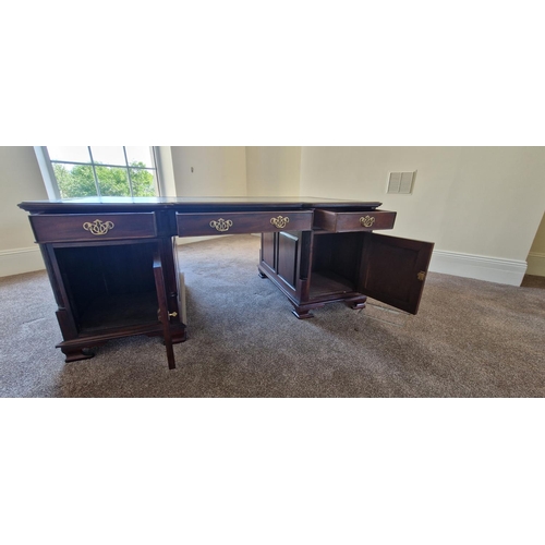 21 - A VERY FINE MAHOGANY LEATHER TOPPED PARTNERS DESK, the concave break front to the front and back add... 