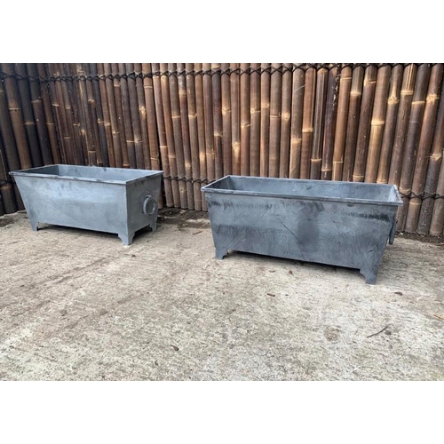 247 - A PAIR OF LARGE GALVANISED METAL PLANTERS, each 4ft long and 50cm tall approximately.