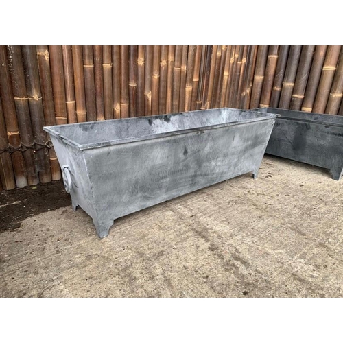 247 - A PAIR OF LARGE GALVANISED METAL PLANTERS, each 4ft long and 50cm tall approximately.