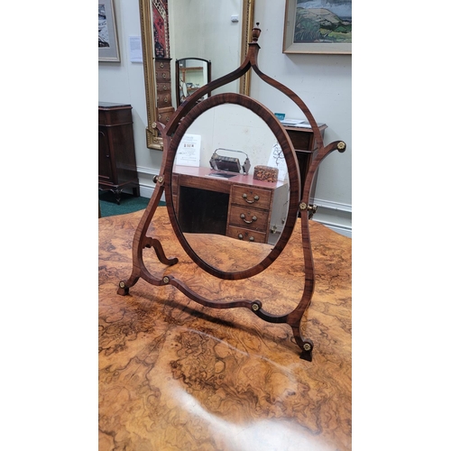 33 - A VERY FINE GEORGE III ROSEWOOD / MAHOGANY SKELETON DRESSING MIRROR, circa 1795, the oval shaped swi... 