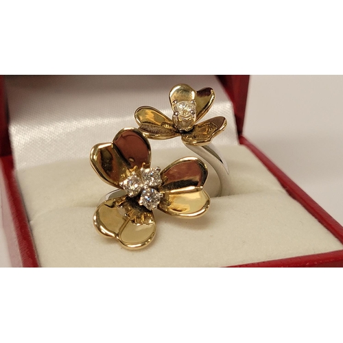 5 - A PRETTY DYNAMIC 9CT GOLD & DIAMOND DAISY RING, the ring has two daisies each with moving petals aro... 