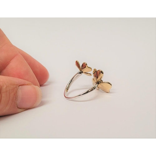 5 - A PRETTY DYNAMIC 9CT GOLD & DIAMOND DAISY RING, the ring has two daisies each with moving petals aro... 