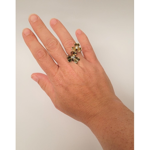 5 - A PRETTY DYNAMIC 9CT GOLD & DIAMOND DAISY RING, the ring has two daisies each with moving petals aro... 