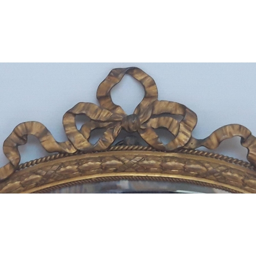 53 - A GOOD QUALITY 19TH CENTURY GILT BRASS MIRROR, with serpentine shape, decorated with a barley twist ... 