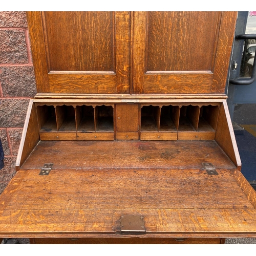 55 - A GOOD QUALITY GEORGIAN SECRETAIRE BOOKCASE, topped with a fluted cornice over double doors that ope... 