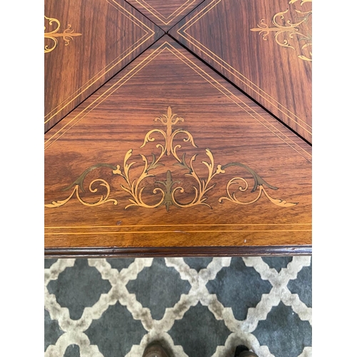 57 - A FINE ROSEWOOD INLAID ENVELOPE CARD TABLE, with decorative inlaid detail to the four envelope leave... 