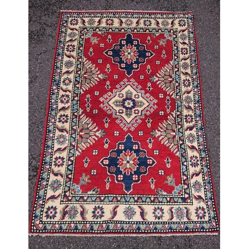 59 - A LOVELY AFGHAN KAZAK RUG, material: hand spun wool with natural organic dyes; design: this rug feat... 