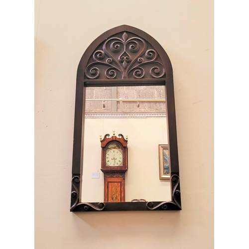 69 - A GOOD QUALITY EARLY 20TH CENTURY WALL MIRROR, Arts & Crafts style, with gothic shape and scrolling ... 