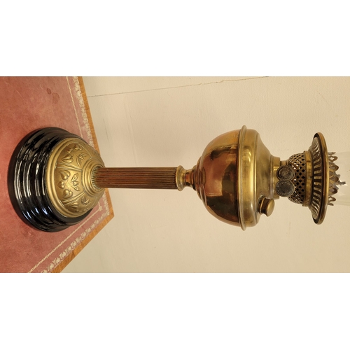 70 - A GOOD QUALITY VERITAS BRASS OIL LAMP, with brass reservoir held on a reeded column with a circular ... 