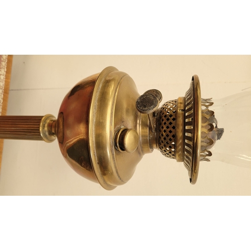 70 - A GOOD QUALITY VERITAS BRASS OIL LAMP, with brass reservoir held on a reeded column with a circular ... 