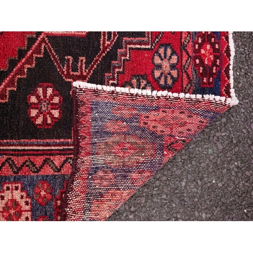 11 - A VINTAGE HAND-KNOTTED RUNNER RUG, material: hand spun wool with natural organic dyes; this rug feat... 