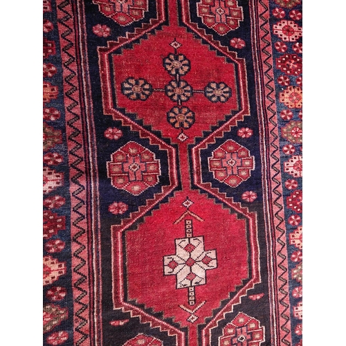 11 - A VINTAGE HAND-KNOTTED RUNNER RUG, material: hand spun wool with natural organic dyes; this rug feat... 