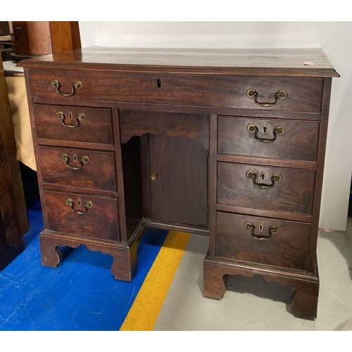 126 - A GEORGIAN MAHOGANY WRITING DESK, with six drawers with brass handles, central drawer opening to fit... 