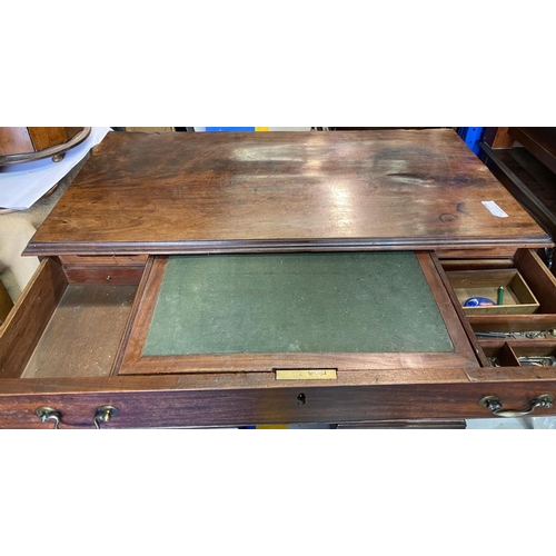 126 - A GEORGIAN MAHOGANY WRITING DESK, with six drawers with brass handles, central drawer opening to fit... 