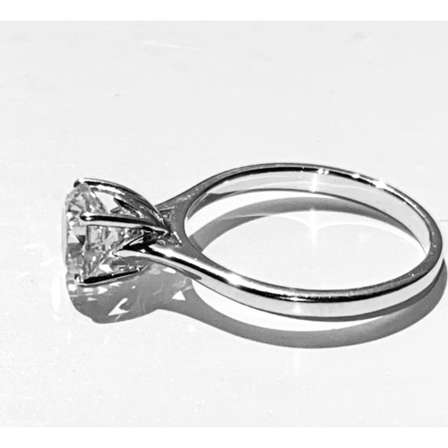 134 - A STUNNING 18CT WHITE GOLD SOLITAIRE RING, this superb round brilliant cut diamond is set in a four ... 