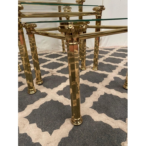 138 - A GOOD QUALITY NEST OF THREE BRASS TABLES, with bevelled glass tops on brass Corinthian column legs.... 