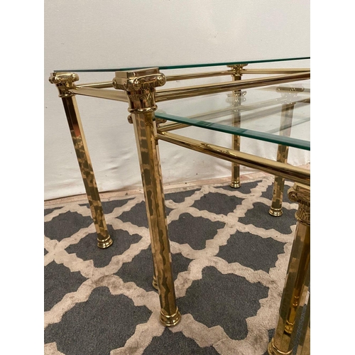 138 - A GOOD QUALITY NEST OF THREE BRASS TABLES, with bevelled glass tops on brass Corinthian column legs.... 