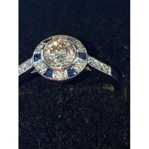 142 - AN ART DECO 18CT WHITE GOLD SAPPHIRE AND DIAMOND TARGET RING, the centre diamond weights .50cts and ... 