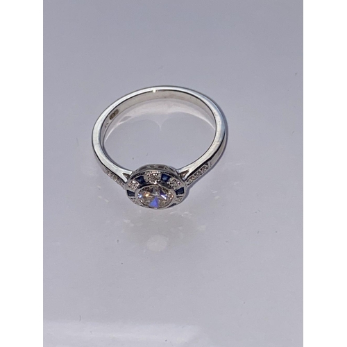 142 - AN ART DECO 18CT WHITE GOLD SAPPHIRE AND DIAMOND TARGET RING, the centre diamond weights .50cts and ... 