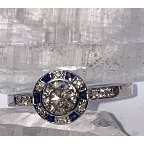 142 - AN ART DECO 18CT WHITE GOLD SAPPHIRE AND DIAMOND TARGET RING, the centre diamond weights .50cts and ... 