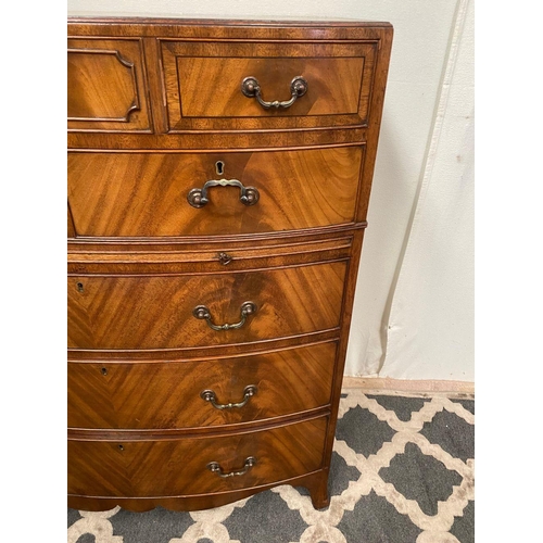 15 - A GOOD QUALITY BOW FRONTED CHEST OF DRAWERS, with brush slide in centre, five drawers with brass han... 