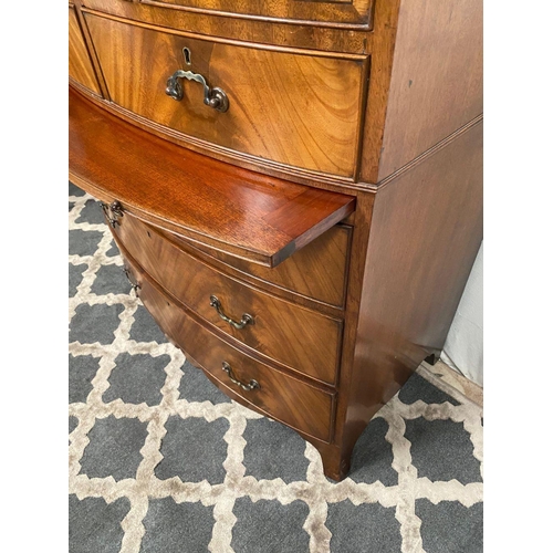 15 - A GOOD QUALITY BOW FRONTED CHEST OF DRAWERS, with brush slide in centre, five drawers with brass han... 