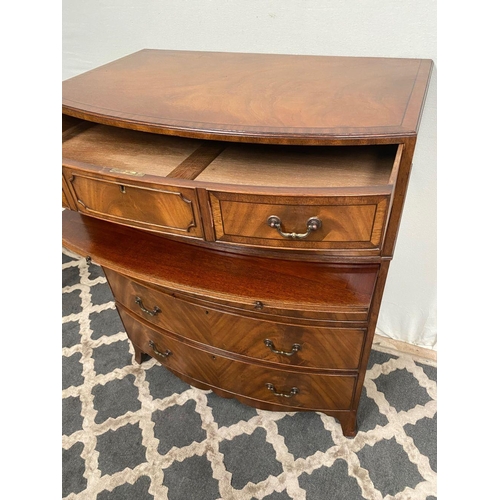 15 - A GOOD QUALITY BOW FRONTED CHEST OF DRAWERS, with brush slide in centre, five drawers with brass han... 