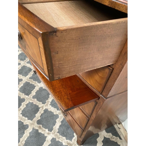 15 - A GOOD QUALITY BOW FRONTED CHEST OF DRAWERS, with brush slide in centre, five drawers with brass han... 