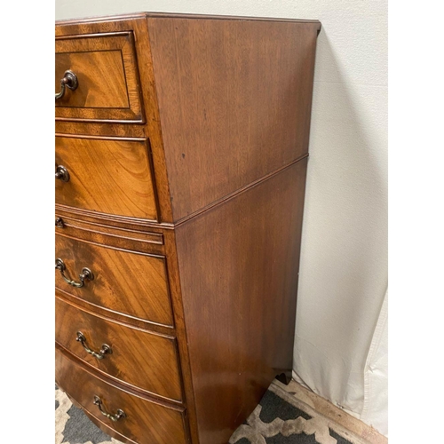 15 - A GOOD QUALITY BOW FRONTED CHEST OF DRAWERS, with brush slide in centre, five drawers with brass han... 