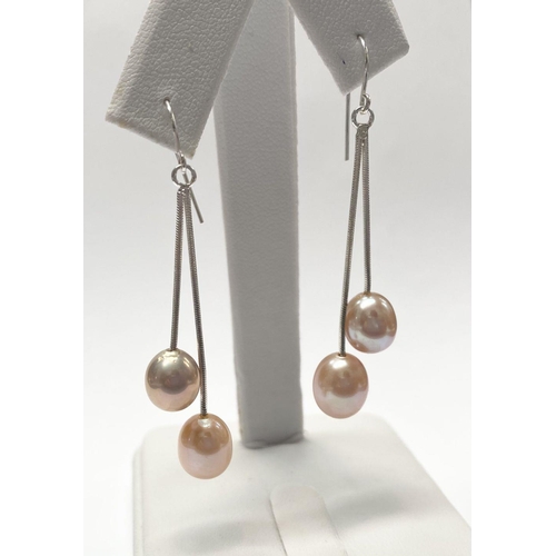 156 - A BEAUTIFUL PAIR OF FRESHWATER CULTURED PEARL DROP EARRINGS, each with a pair of delicate cultured p... 