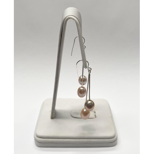 156 - A BEAUTIFUL PAIR OF FRESHWATER CULTURED PEARL DROP EARRINGS, each with a pair of delicate cultured p... 