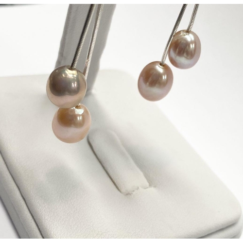 156 - A BEAUTIFUL PAIR OF FRESHWATER CULTURED PEARL DROP EARRINGS, each with a pair of delicate cultured p... 