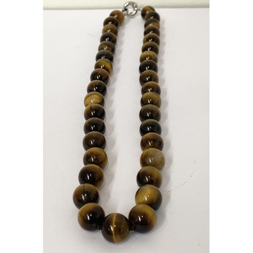 175 - A TIGERSEYE BEADED NECKLACE, lovely tigerseye beads with silver tone clasp. Dimensions: 50cm long ap... 