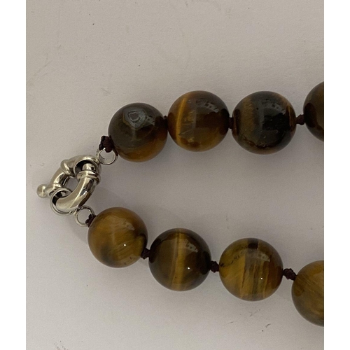 175 - A TIGERSEYE BEADED NECKLACE, lovely tigerseye beads with silver tone clasp. Dimensions: 50cm long ap... 