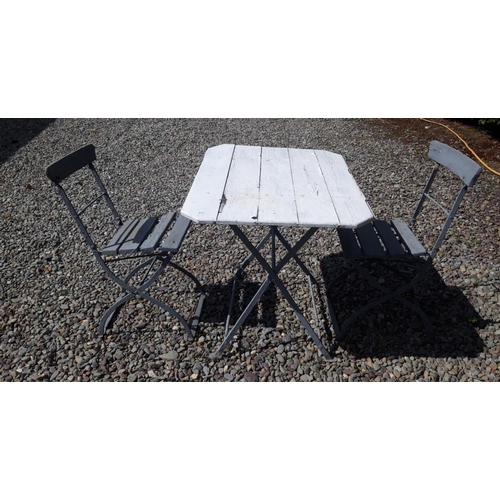 179 - AN ANTIQUE GARDEN TABLE ALONG WITH TWO RELATED CHAIRS, with wrought iron frames. Dimensions: table: ... 