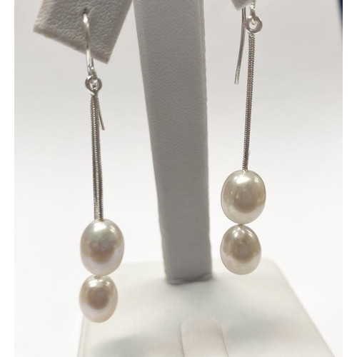 23 - A LOVELY PAIR OF CULTURED PEARL DROP EARRINGS, each with a pair of delicate cultured pearls suspende... 