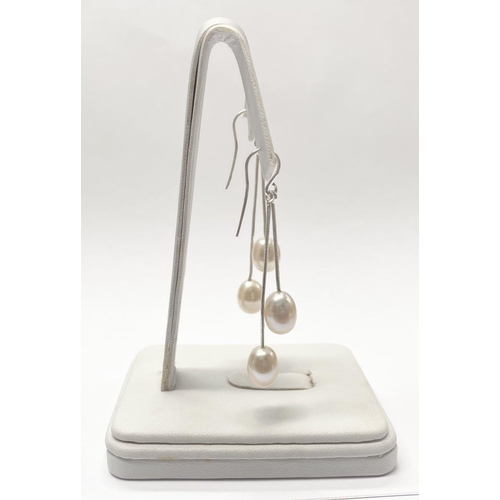 23 - A LOVELY PAIR OF CULTURED PEARL DROP EARRINGS, each with a pair of delicate cultured pearls suspende... 