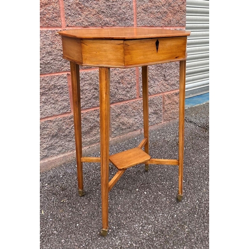 28 - A MID CENTURY OCTAGONAL BIRCH SEWING TABLE, opening to fitter interior, supported by tapered legs un... 