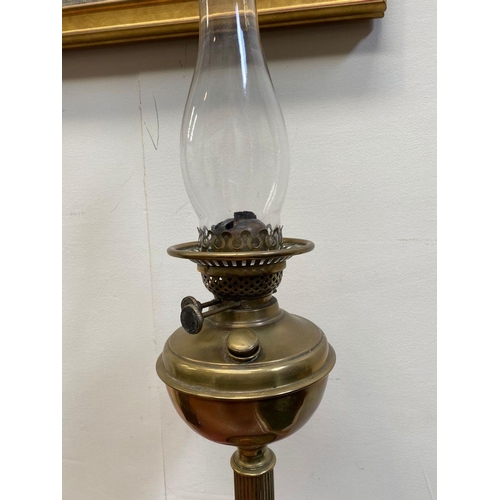 37 - A GOOD QUALITY VERITAS BRASS OIL LAMP, with brass reservoir held on a reeded column with a circular ... 