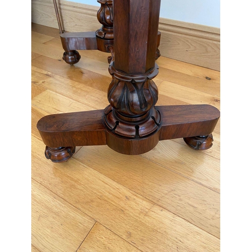 48 - A WILLIAM IV ROSEWOOD GAMES TABLE, with draught board to interior, standing on column legs supported... 