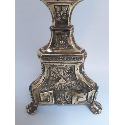 80 - A LARGE 18TH CENTURY ORNATE GILT CANDLESTICK, with shaped column engraved throughout standing on lio... 