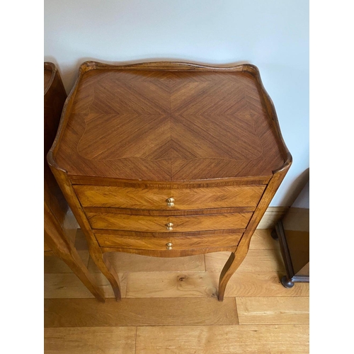 83 - A PAIR OF WALNUT THREE DRAWER SIDE CABINETS/LAMP TABLES, with shaped galleried top and crossbanded p... 