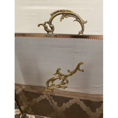 9 - A BRASS THREE PANEL FIRESCREEN, with scroll detail to front and handle. Dimensions: 64cm high x 80cm... 